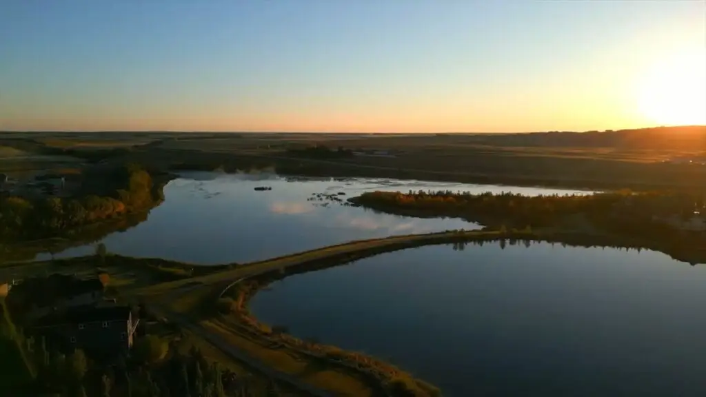 Aerial view of Cochrane Lake and the MonTerra community at sunset